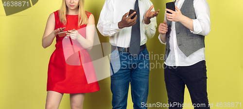 Image of Group of friends using mobile smartphones. Teenagers addiction to new technology trends. Close up.