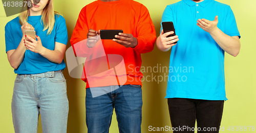 Image of Group of friends using mobile smartphones. Teenagers addiction to new technology trends. Close up.