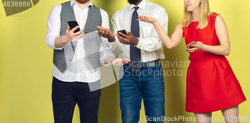 Image of Group of friends using mobile smartphones. Teenagers addiction to new technology trends. Close up.