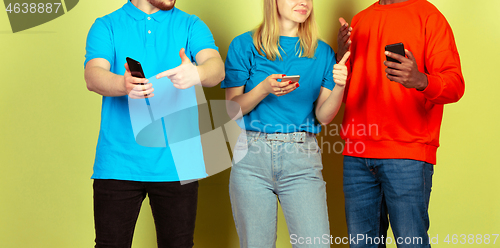 Image of Group of friends using mobile smartphones. Teenagers addiction to new technology trends. Close up.