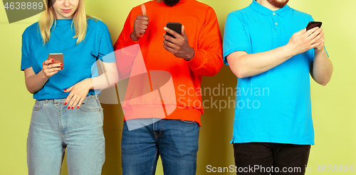 Image of Group of friends using mobile smartphones. Teenagers addiction to new technology trends. Close up.