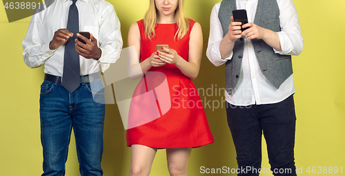 Image of Group of friends using mobile smartphones. Teenagers addiction to new technology trends. Close up.