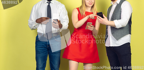 Image of Group of friends using mobile smartphones. Teenagers addiction to new technology trends. Close up.