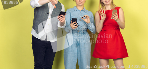 Image of Group of friends using mobile smartphones. Teenagers addiction to new technology trends. Close up.