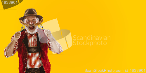 Image of Smiling men with sausages dressed in traditional Austrian or Bavarian costume holding mug of beer at pub or studio. The celebration, oktoberfest, festival