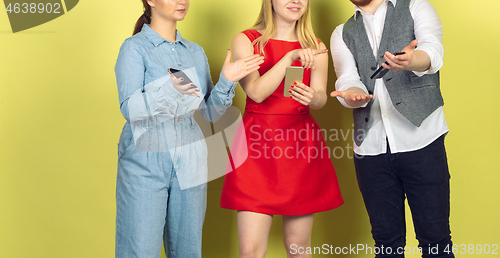 Image of Group of friends using mobile smartphones. Teenagers addiction to new technology trends. Close up.