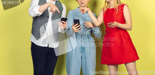 Image of Group of friends using mobile smartphones. Teenagers addiction to new technology trends. Close up.