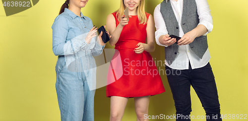 Image of Group of friends using mobile smartphones. Teenagers addiction to new technology trends. Close up.