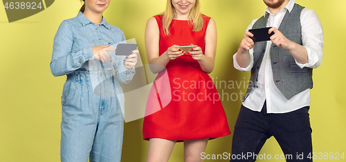 Image of Group of friends using mobile smartphones. Teenagers addiction to new technology trends. Close up.