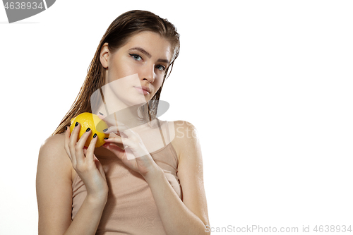 Image of Youth secrets. Beautiful young woman with lemon over white background. Cosmetics and makeup, natural and eco treatment, skin care.