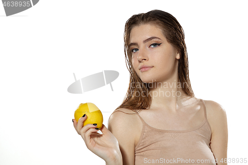 Image of Youth secrets. Beautiful young woman with lemon over white background. Cosmetics and makeup, natural and eco treatment, skin care.