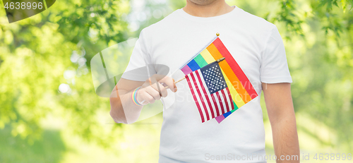 Image of man with gay pride rainbow flag and wristband