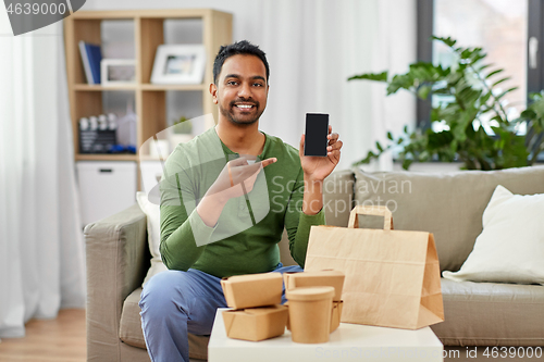 Image of indian man using smartphone for food delivery