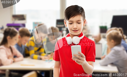 Image of boy in red t-shirt with headphones and smartphone