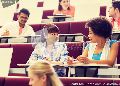 Image of group of students talking in lecture hall