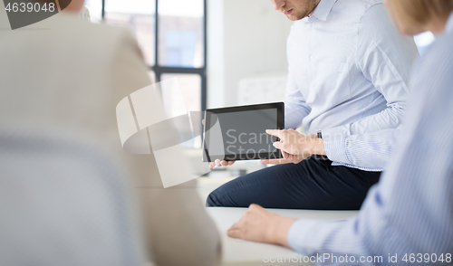 Image of close up of business team with tablet pc at office