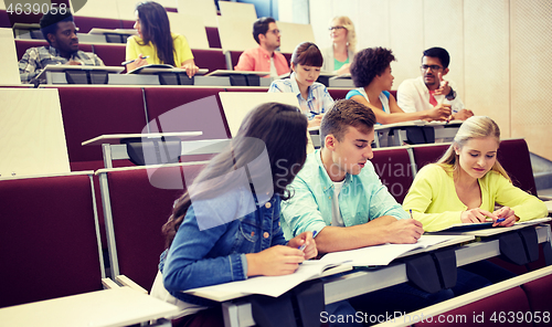 Image of group of students with notebooks at lecture hall