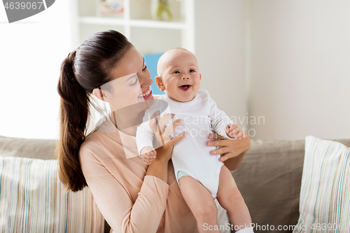 Image of happy mother with little baby boy at home