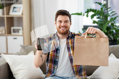 Image of man using smartphone for food delivery