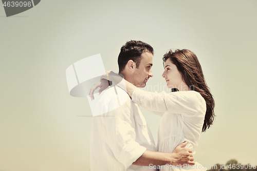 Image of happy young couple have fun on beach