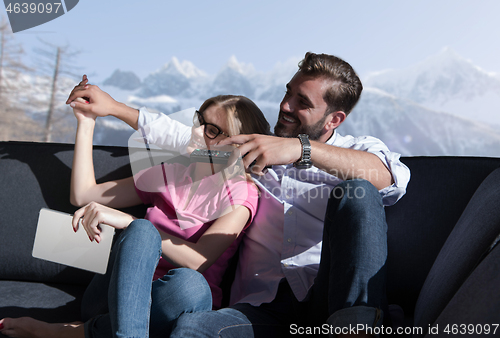 Image of Young couple watching television