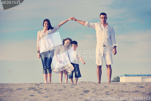 Image of family on beach showing home sign