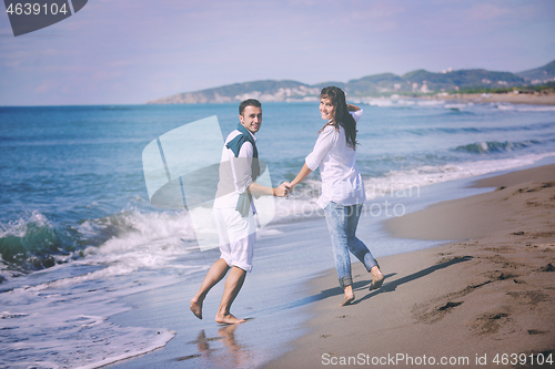 Image of happy young couple have fun at beautiful beach