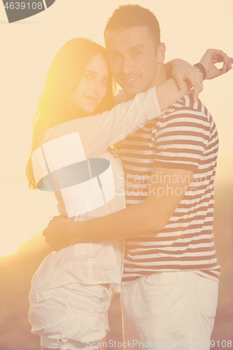 Image of happy young couple have romantic time on beach