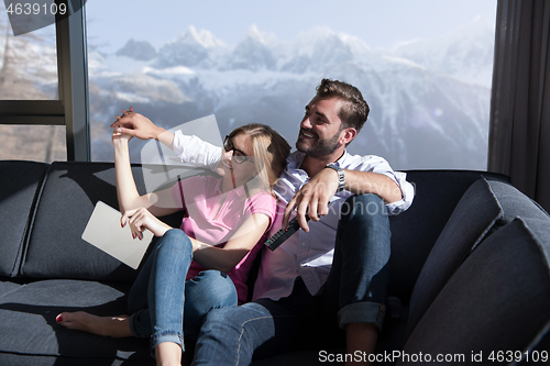 Image of Young couple watching television