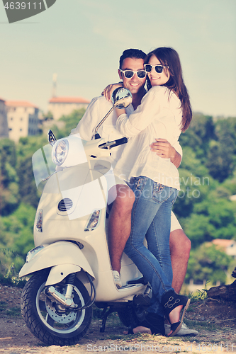 Image of Portrait of happy young love couple on scooter enjoying summer t