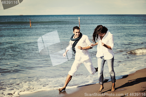 Image of happy young couple have fun at beautiful beach