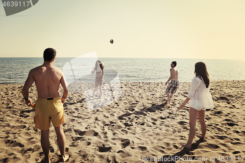 Image of young people group have fun and play beach volleyball