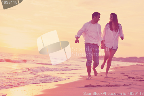 Image of young couple  on beach have fun