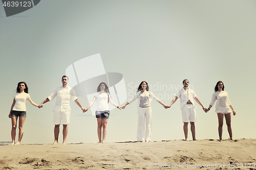 Image of happy people group have fun and running on beach
