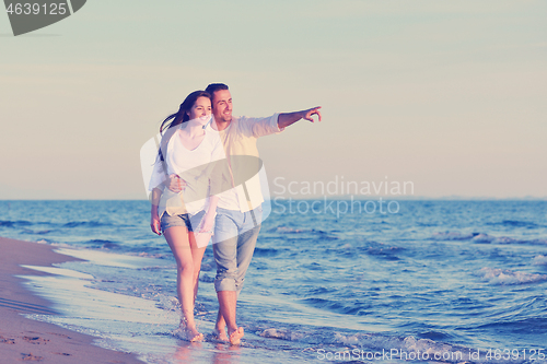 Image of young couple  on beach have fun