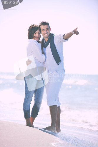 Image of happy young couple have fun at beautiful beach