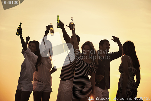 Image of Group of young people enjoy summer  party at the beach