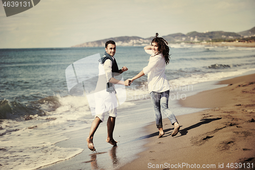 Image of happy young couple have fun at beautiful beach