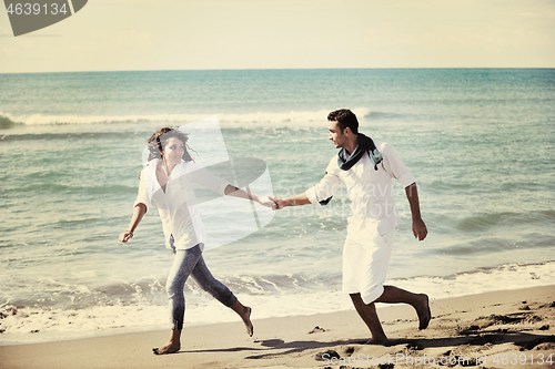 Image of happy young couple have fun at beautiful beach