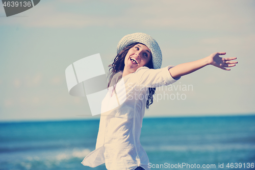 Image of happy young woman on beach