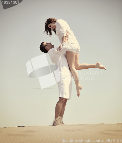 Image of happy young couple have fun on beach