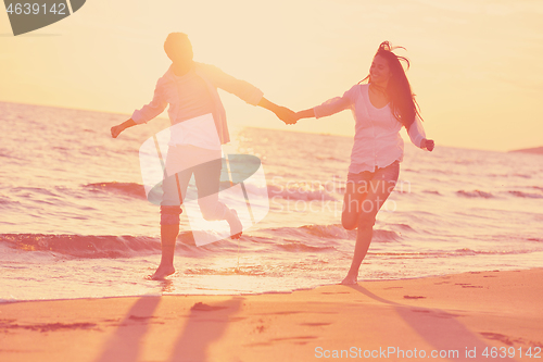 Image of young couple  on beach have fun