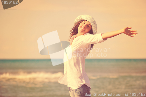 Image of happy young woman on beach