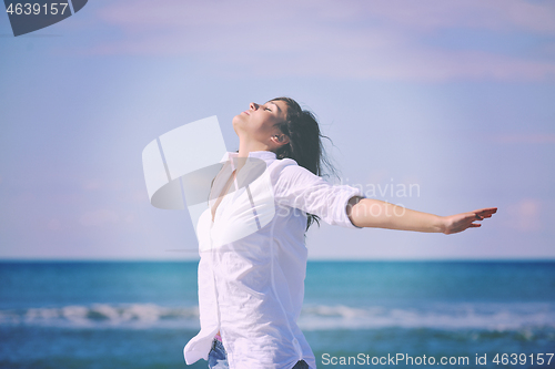 Image of happy young woman on beach