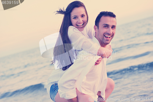 Image of young couple  on beach have fun