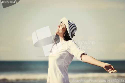 Image of happy young woman on beach