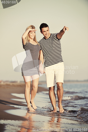Image of happy young couple have romantic time on beach