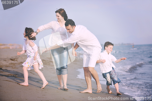 Image of happy young family have fun on beach