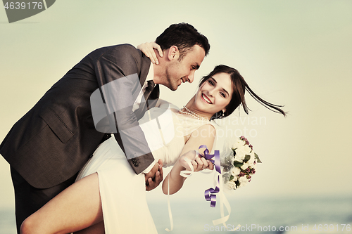 Image of romantic beach wedding at sunset