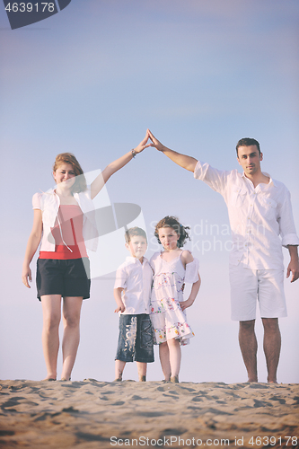 Image of family on beach showing home sign
